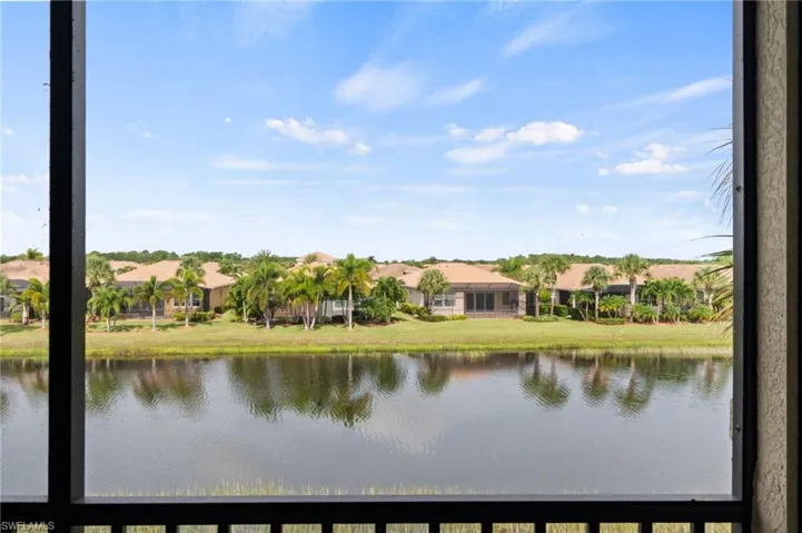Screened outdoor space with water frontage, offering expansive water scenery and distant residential structures
