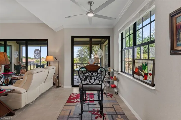 Vaulted ceilings, a ceiling fan, and large windows with transom details