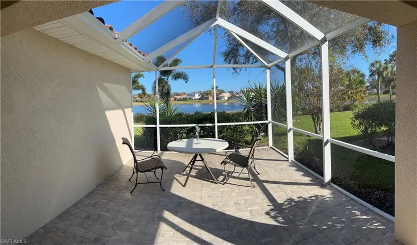 Sunroom / solarium featuring a water view and lofted ceiling