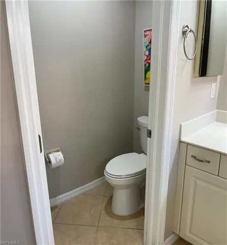 Bathroom with vanity, toilet, and tile patterned floors