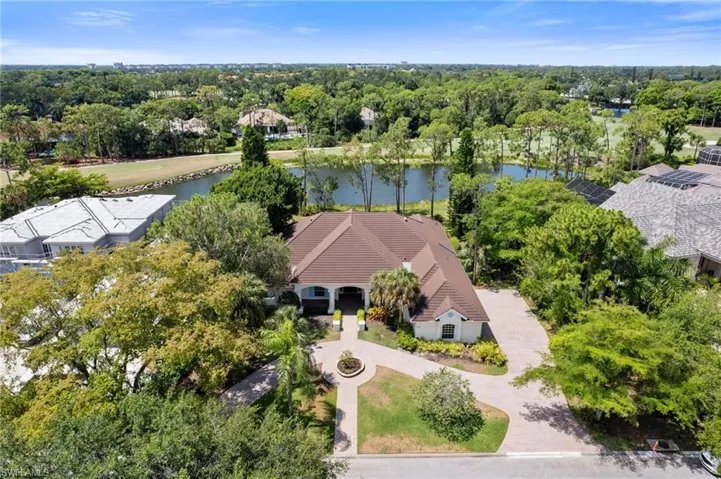 Birds eye view of property with a water view