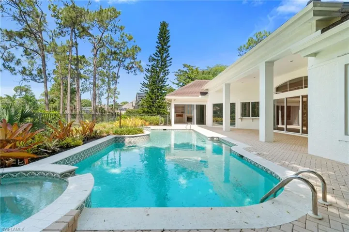 View of swimming pool featuring an in ground hot tub and a patio area