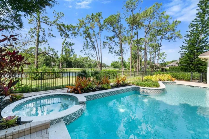 View of pool with an in ground hot tub