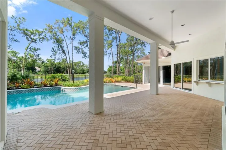 View of pool with a patio area and ceiling fan