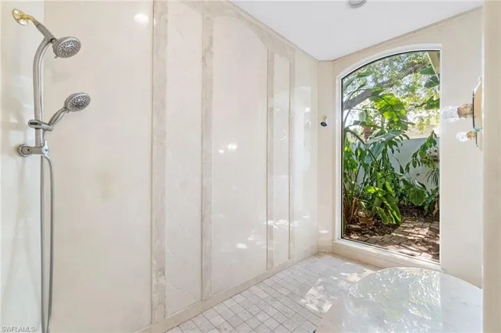 Bathroom with a shower and tile floors