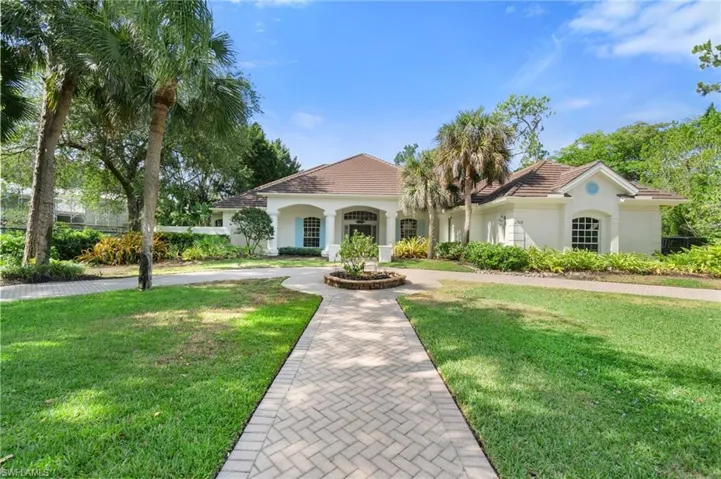 Mediterranean / spanish house with a front lawn