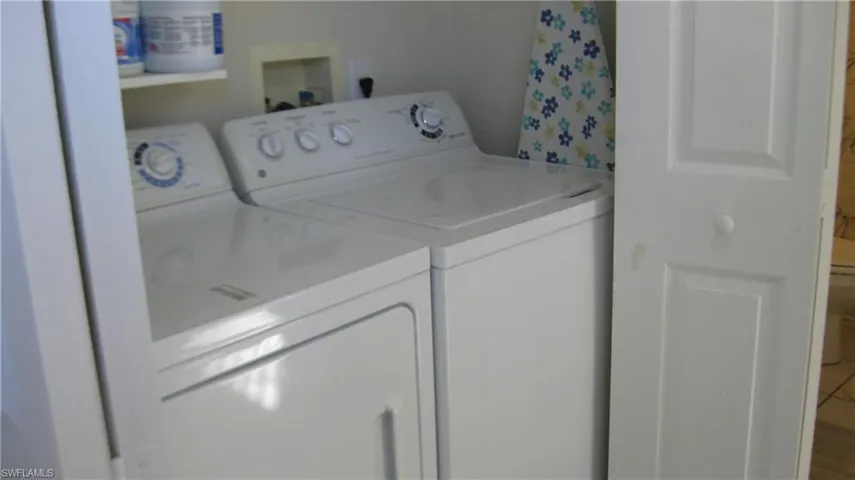 Laundry closet featuring independent washer and dryer