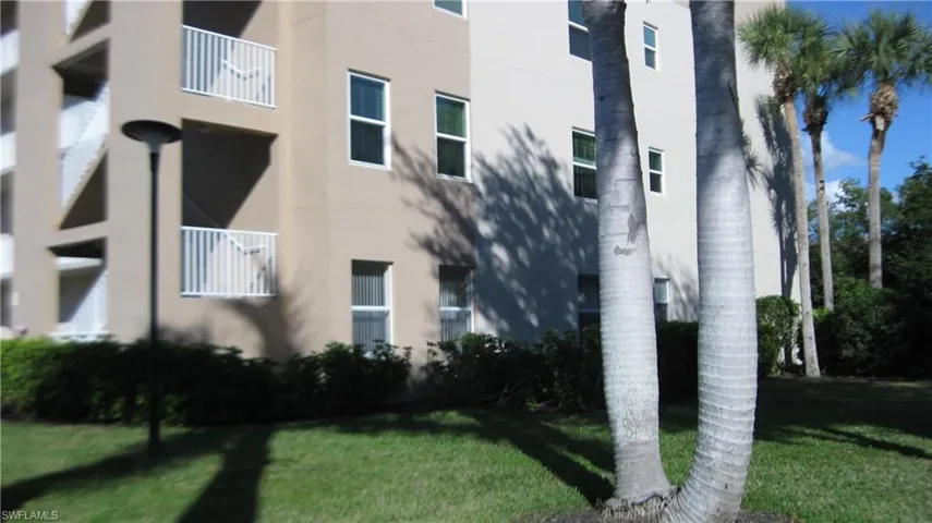 View of side of home with stucco siding and a yardCorner condo.