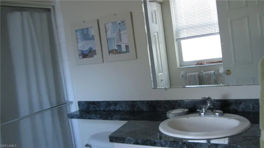 Full bathroom with vanity and a shower with shower door