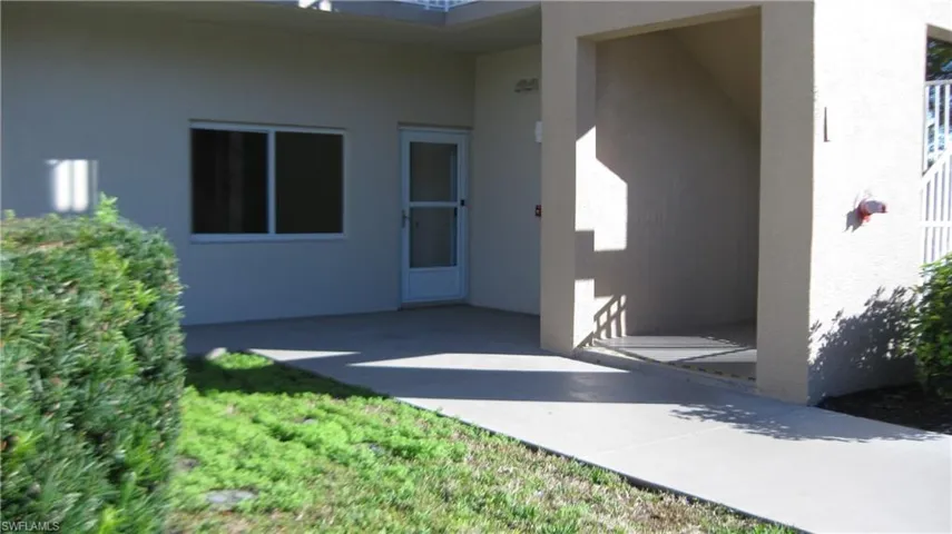 Entrance to property with stucco siding