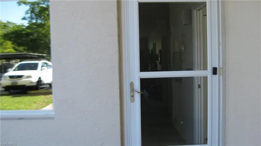 Doorway to property with stucco siding