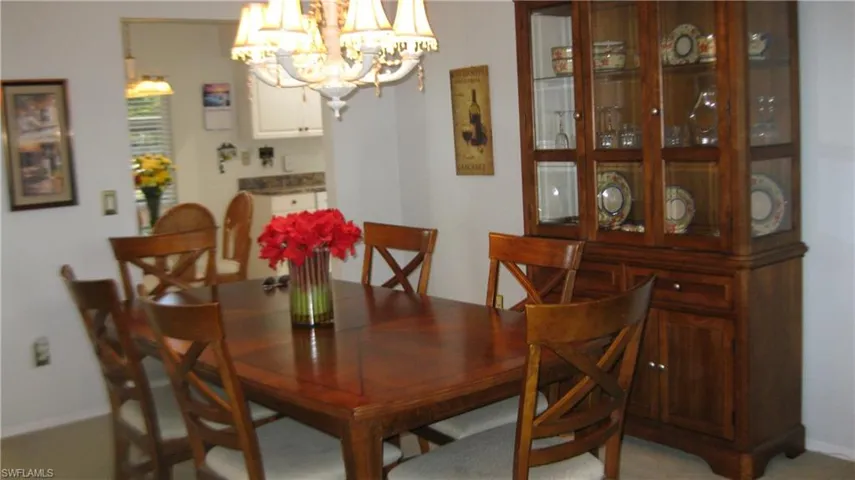 Dining area featuring baseboards and a chandelier
