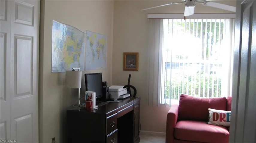 Office area with plenty of natural light and a ceiling fan and closet.