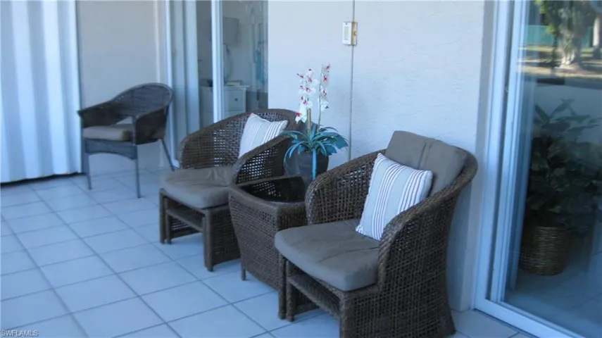 View of lanai with storage closet, access to primary bedroom and living room. View of the lake