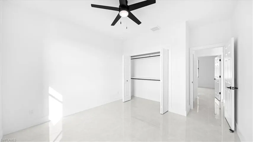 Unfurnished bedroom featuring a closet and a ceiling fan