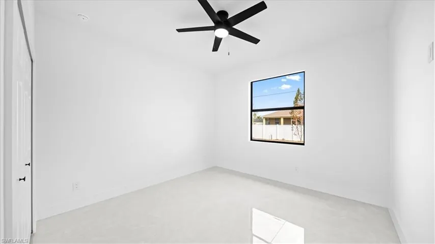 Empty room with baseboards and ceiling fan