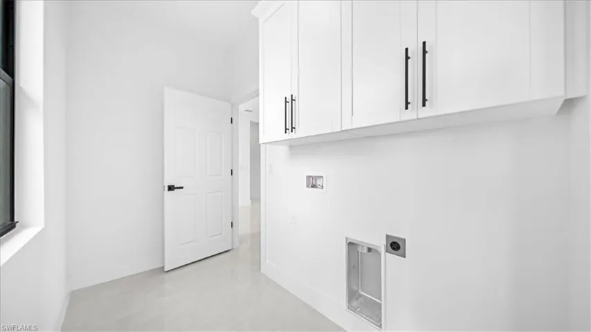 Laundry room featuring cabinet space, washer hookup, and electric dryer hookup