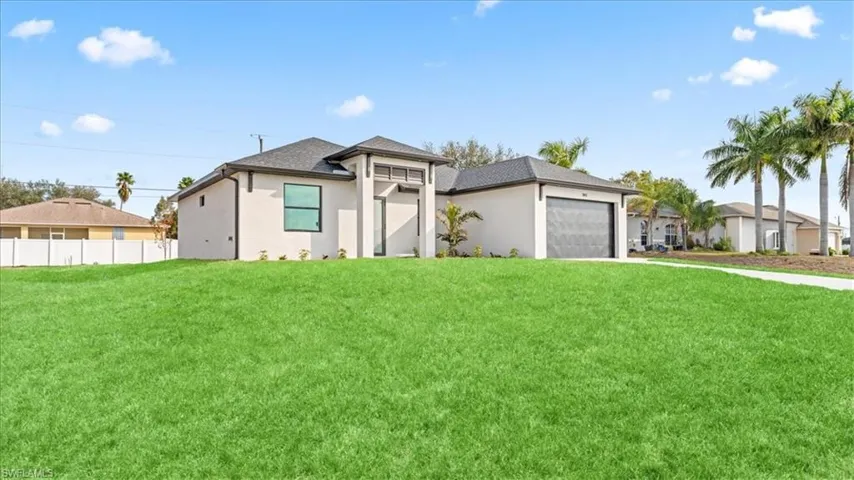 Prairie-style house featuring stucco siding, a garage, concrete driveway, and a shingled roof