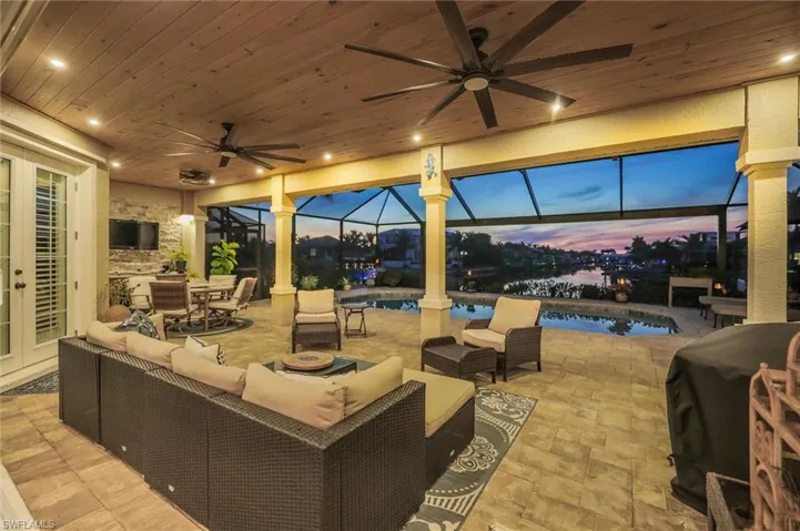 Patio terrace at dusk with outdoor dining area, a patio, and a ceiling fan