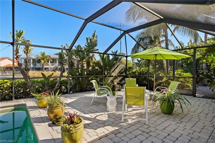 View of patio / terrace featuring a lanai, an outdoor pool, and a sunroom