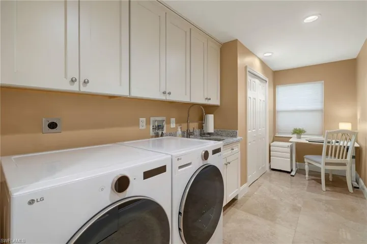 Laundry room featuring cabinet space, washer and clothes dryer, recessed lighting, and light tile patterned flooring