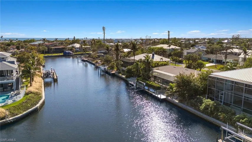 Aerial view of residential area featuring a large body of water