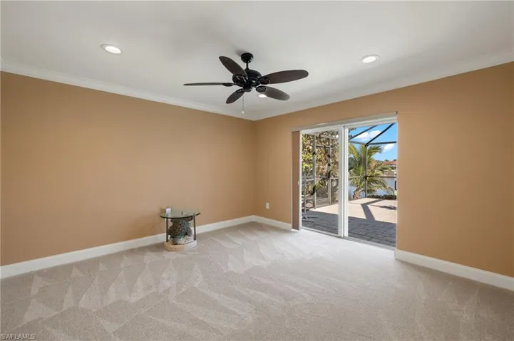 Empty room featuring ornamental molding, carpet, a water view, ceiling fan, and recessed lighting