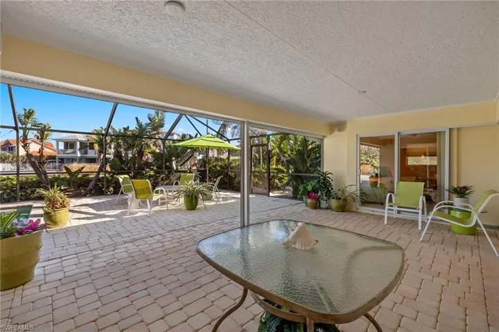 Sunroom featuring a patio
