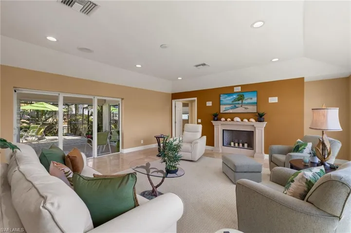 Living room featuring recessed lighting and a fireplace