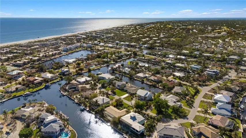 View of property location with a large body of water and nearby suburban area