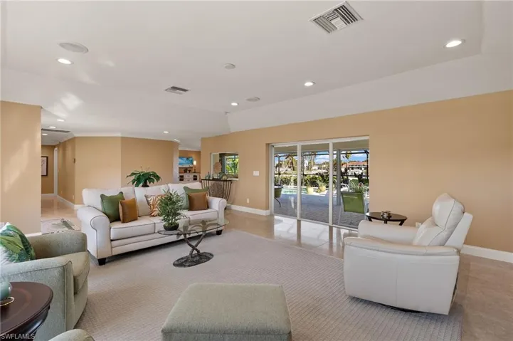 Living area with recessed lighting and light tile patterned flooring