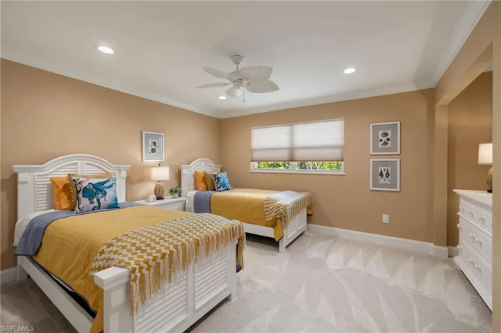 Bedroom with ornamental molding, light carpet, ceiling fan, and recessed lighting