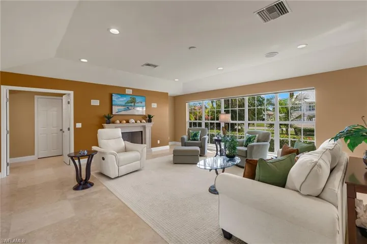 Living area with recessed lighting and baseboards