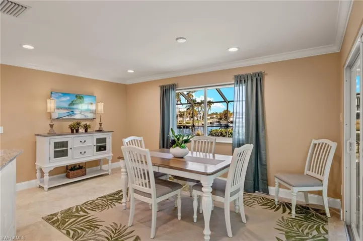 Dining space featuring crown molding, recessed lighting, and light tile patterned floors