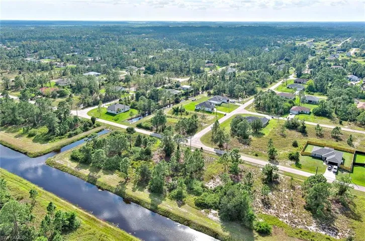 Aerial view of property and surrounding area featuring a large body of water