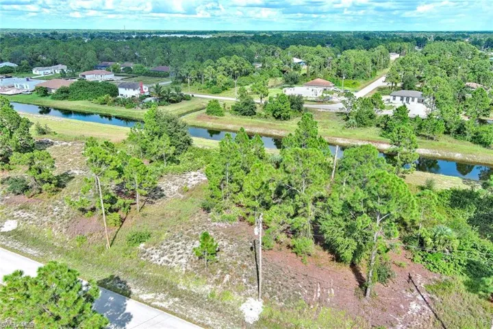 Aerial overview of property's location with a nearby body of water