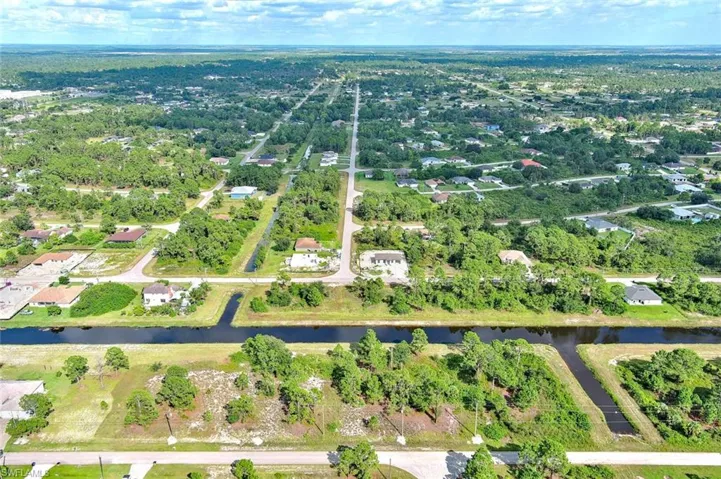 Aerial overview of property's location featuring nearby suburban area