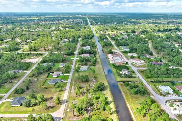 Aerial overview of property's location featuring nearby suburban area and a nearby body of water