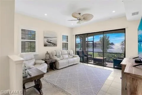 Tiled living area featuring visible vents, recessed lighting, and a ceiling fan