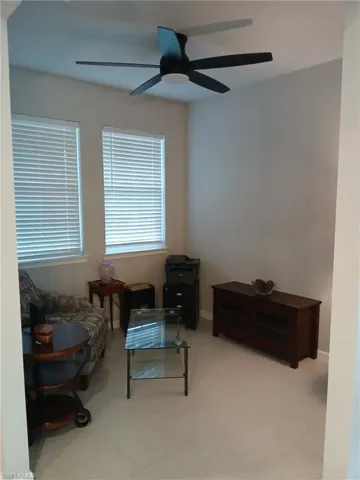Sitting room featuring a ceiling fan