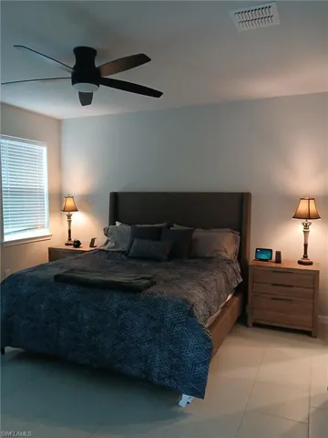 Bedroom featuring ceiling fan and light tile patterned flooring