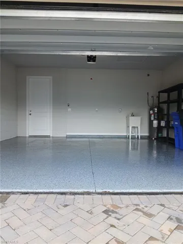 Garage with water heater and a sink