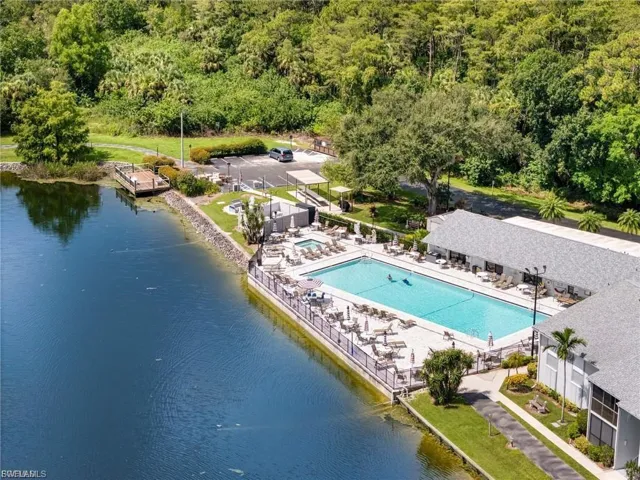 Aerial view of a pool and a nearby body of water