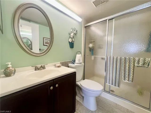 Full bathroom featuring vanity and a stall shower