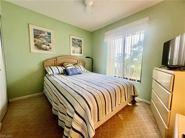 Bedroom with carpet and a textured ceiling