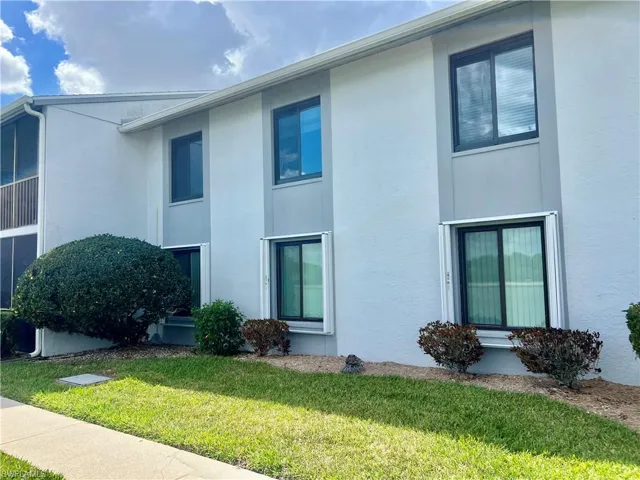 View of property exterior featuring stucco siding and a yard