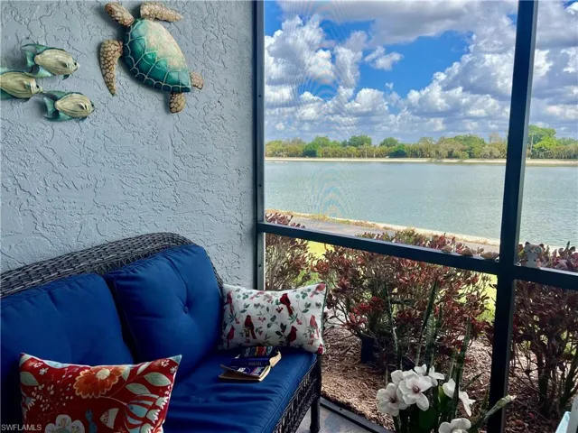 Balcony featuring a sunroom and a water view