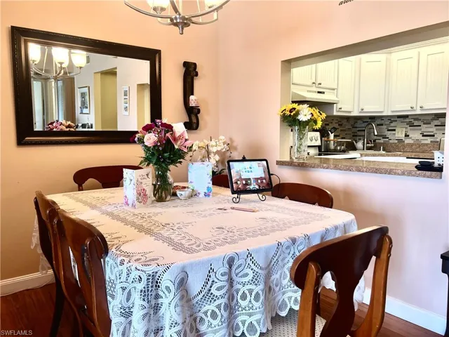 Dining space with a chandelier and wood finished floors