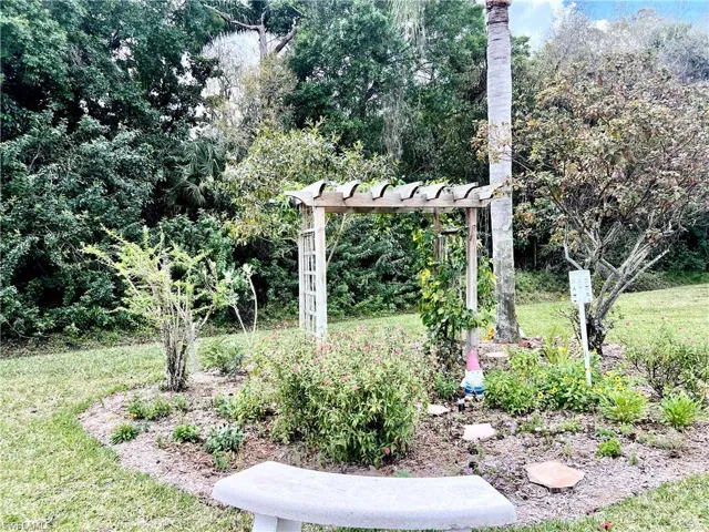 View of grassy yard with a pergola