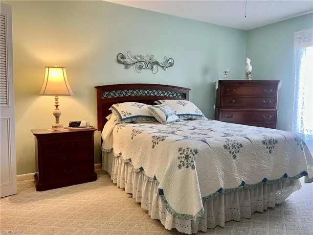 Carpeted bedroom with baseboards